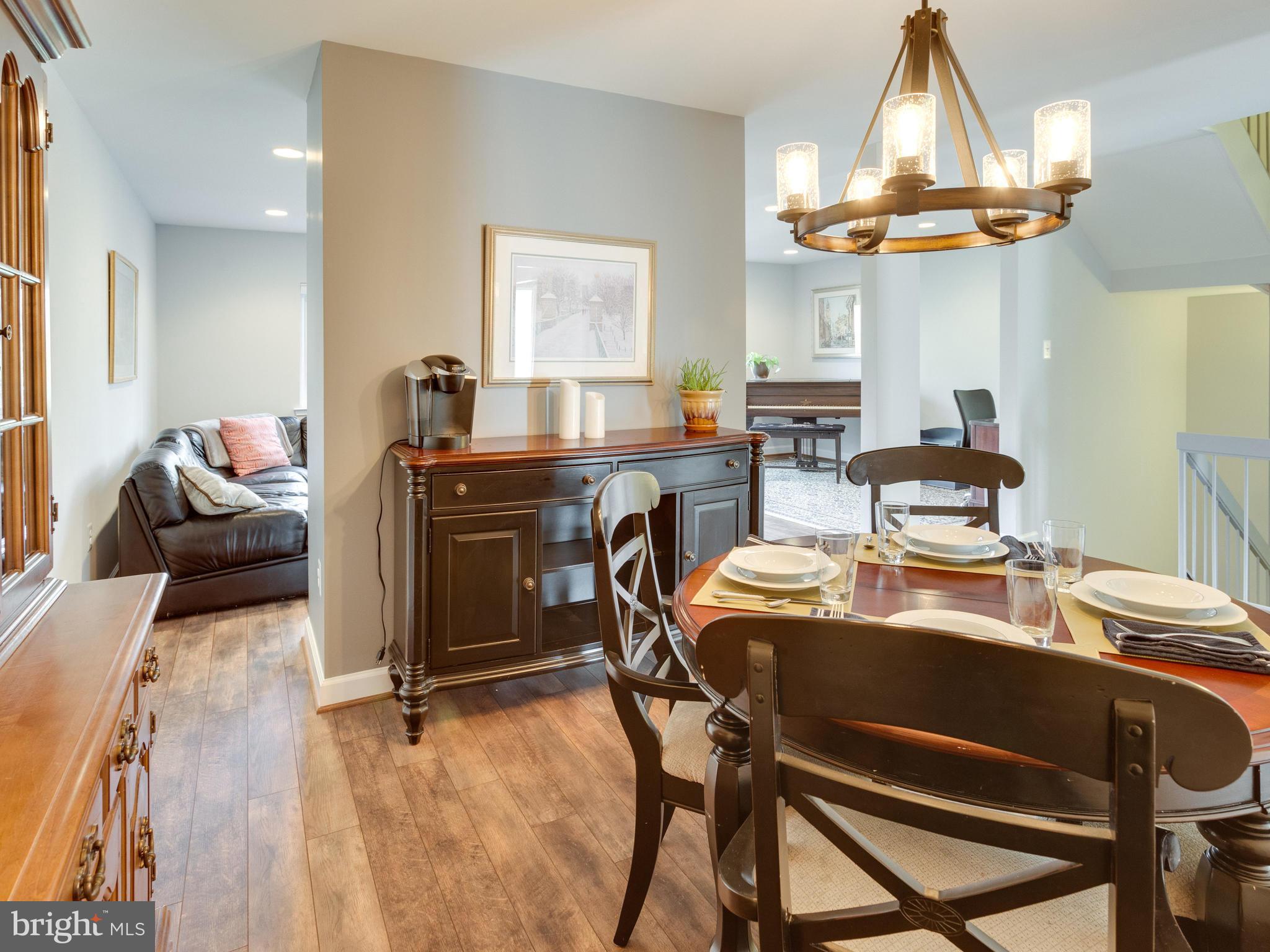 1663 Bachan Court Reston, VA 20190 - Photo 9 of 29 a dining room filled chandelier and wooden floor
