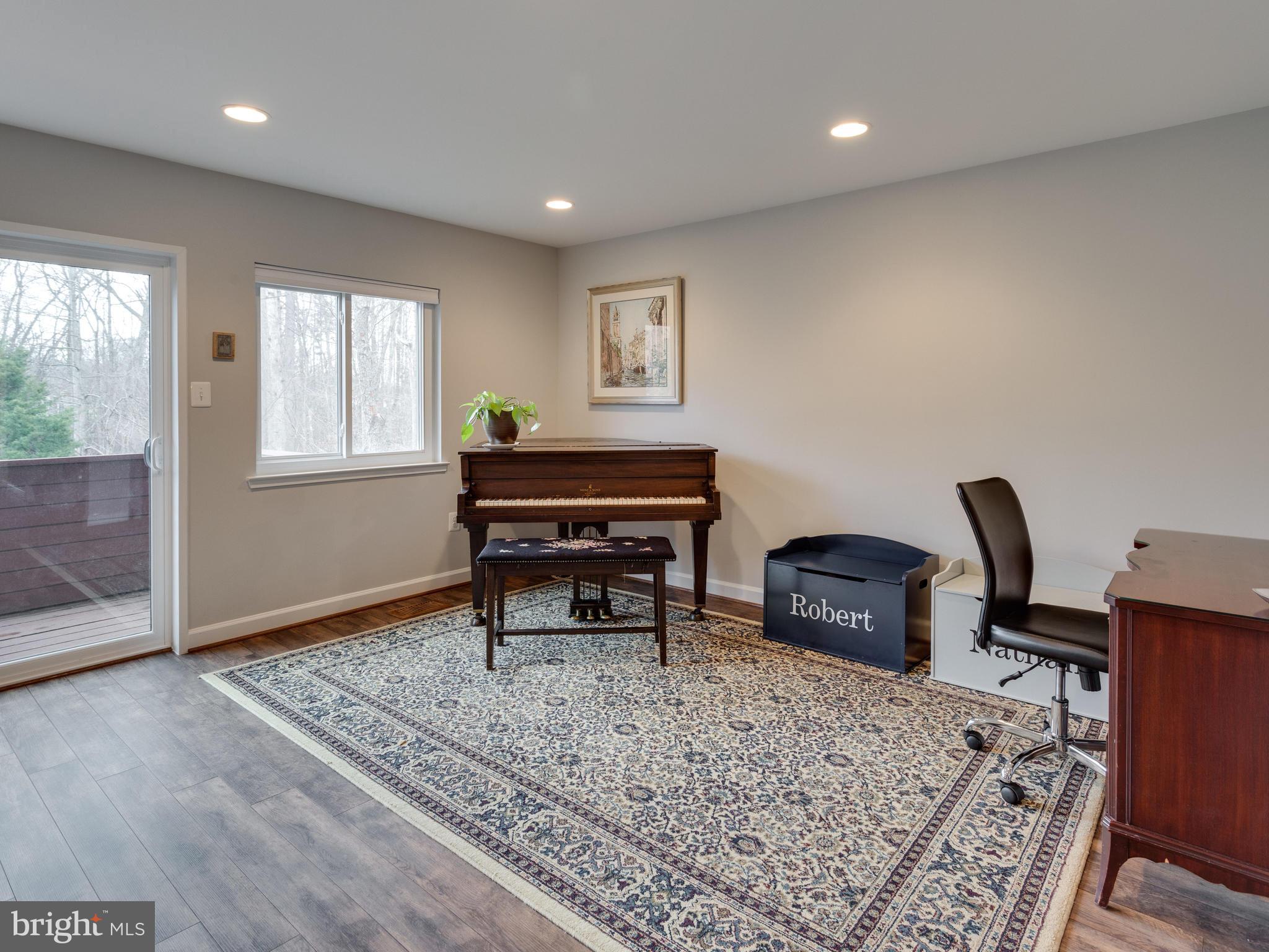 1663 Bachan Court Reston, VA 20190 - Photo 10 of 29 a living room with furniture a piano and wooden floor