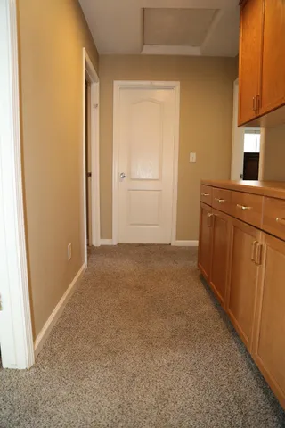 a view of a kitchen cabinets and a wooden shelves