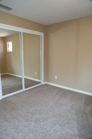 a bedroom with a bed and a dresser