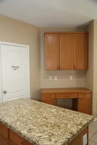 a kitchen with stainless steel appliances a refrigerator a sink a stove top oven and a window