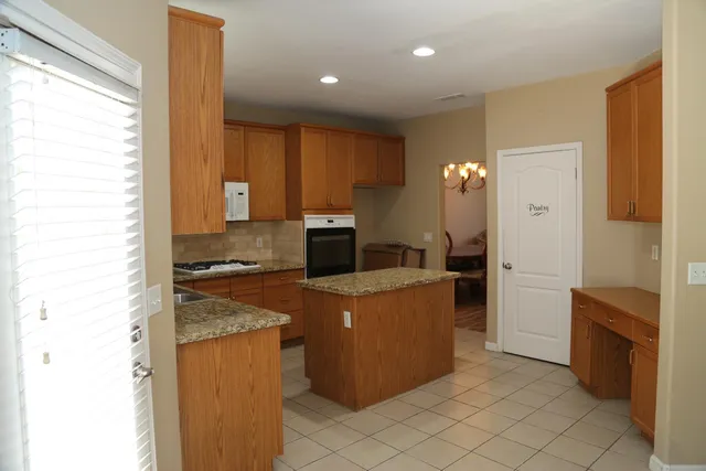 a large kitchen with a stove a refrigerator a sink and dishwasher