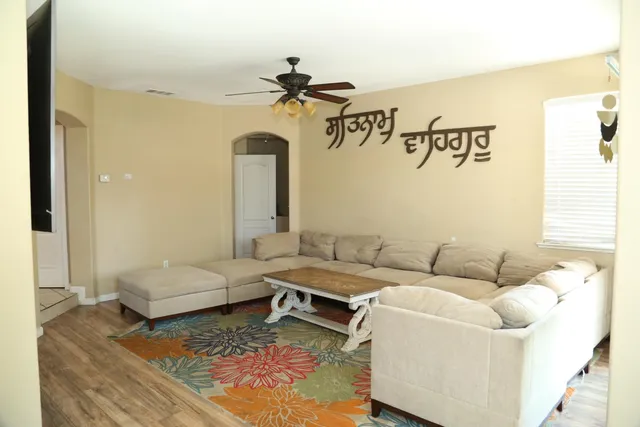 a living room with furniture a fireplace and a flat screen tv