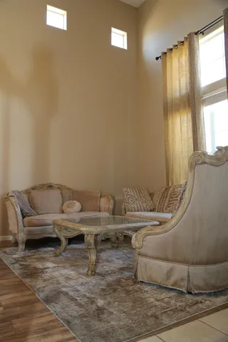 a living room with furniture and a large window