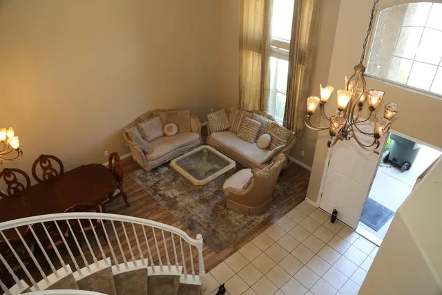 a view of a couches and dinning table in a balcony