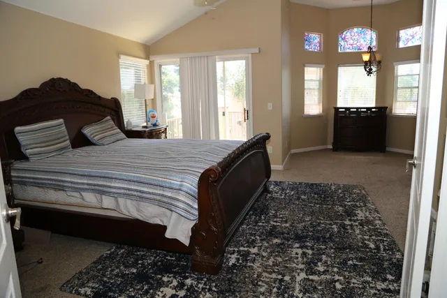 a bedroom with a bed dresser and a window