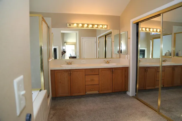 a bathroom with a double vanity sink and mirror
