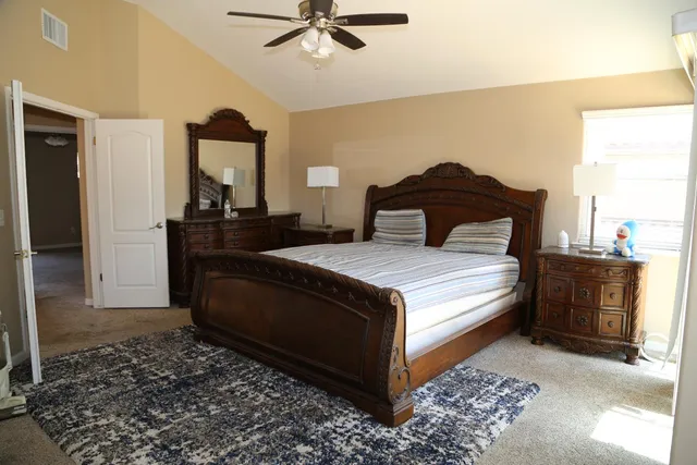 a bedroom with a bed and a dresser