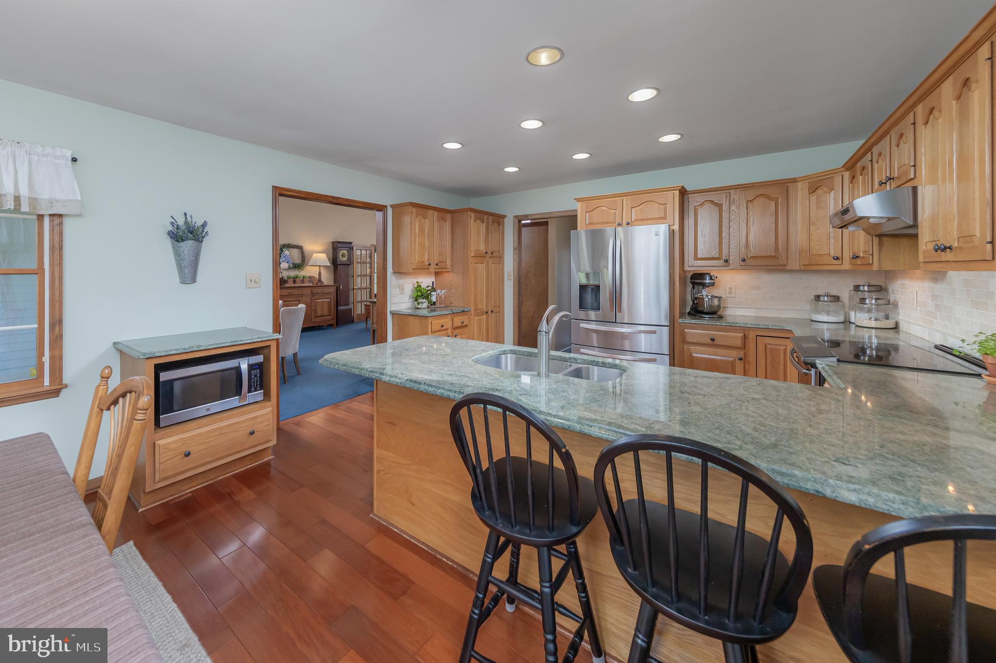 124 Pitman Downer Road Sewell, NJ 08080 - Photo 15 of 71 a kitchen with stainless steel appliances granite countertop a stove a sink a dining table and chairs