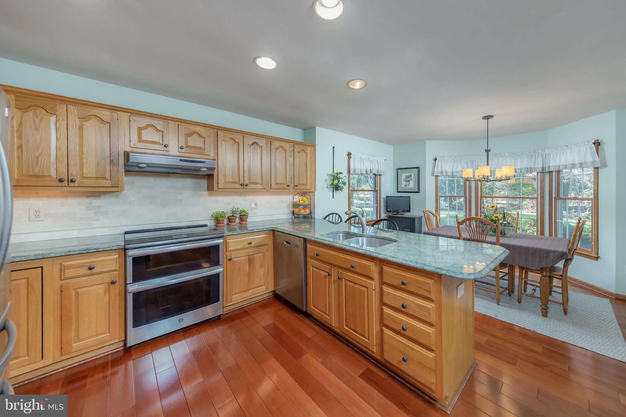 124 Pitman Downer Road Sewell, NJ 08080 - Photo 17 of 71 a kitchen with granite countertop wooden cabinets and white appliances