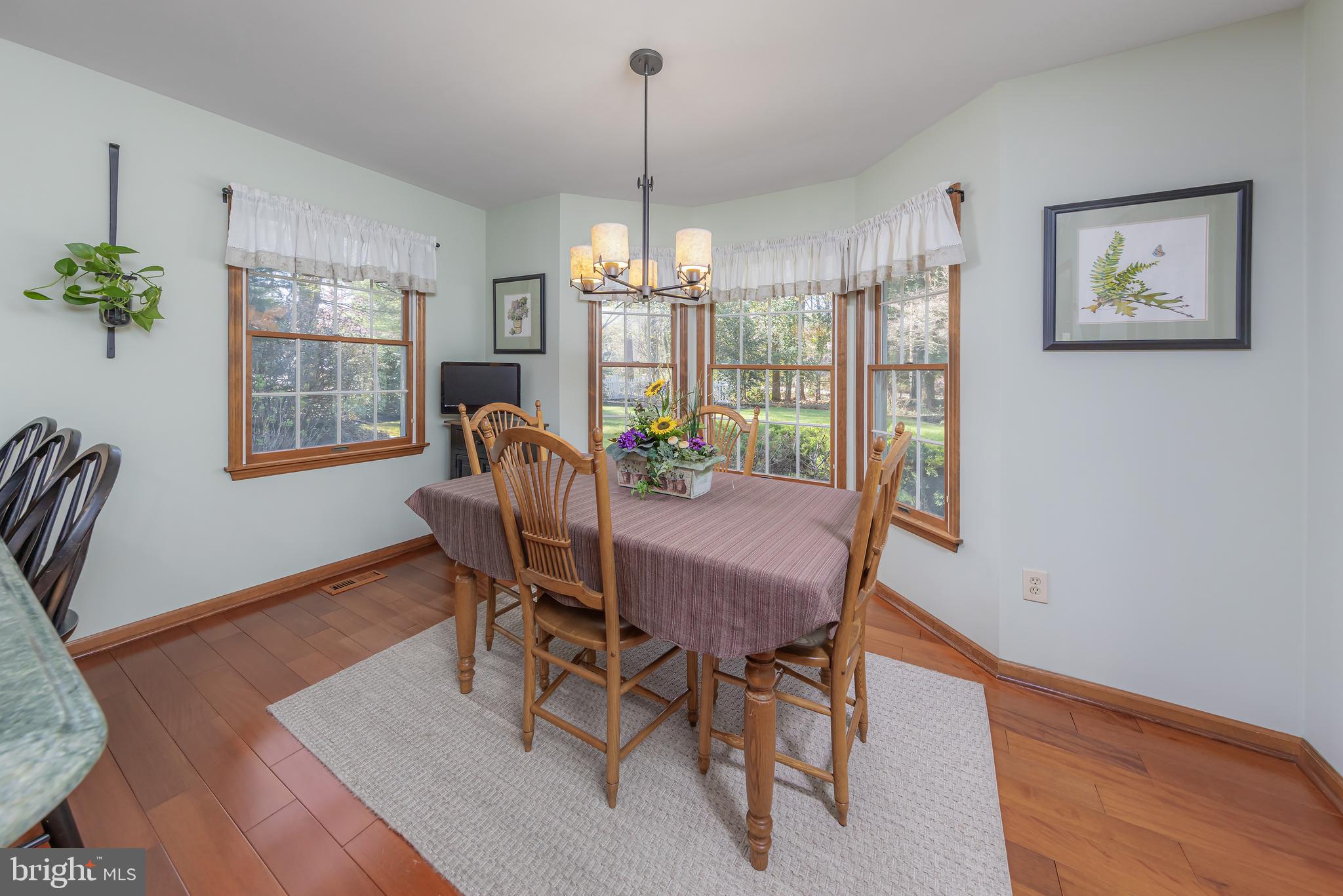 124 Pitman Downer Road Sewell, NJ 08080 - Photo 18 of 71 a dining room with furniture a chandelier and wooden floor