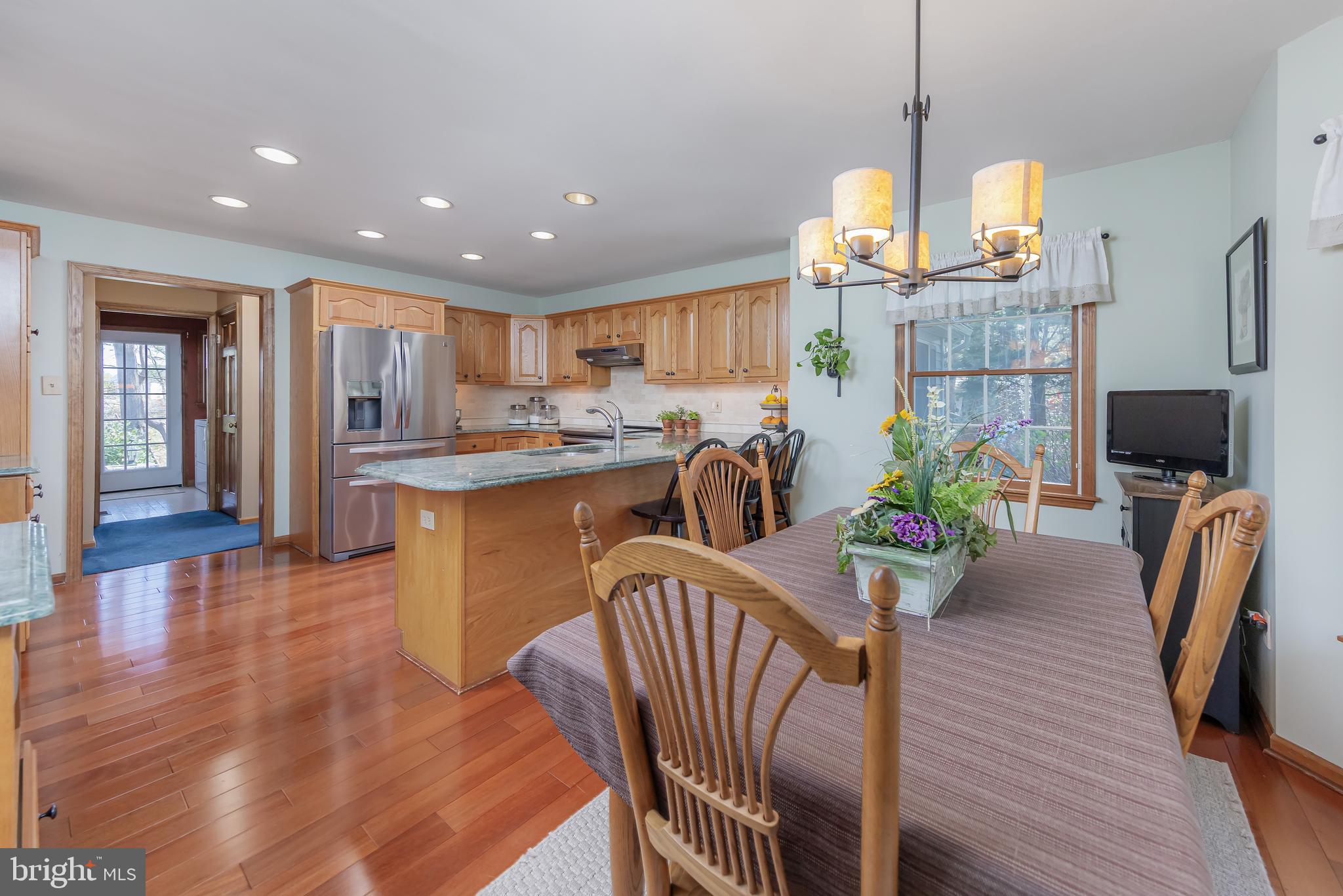124 Pitman Downer Road Sewell, NJ 08080 - Photo 19 of 71 a view of a dining room and livingroom with furniture wooden floor a chandelier