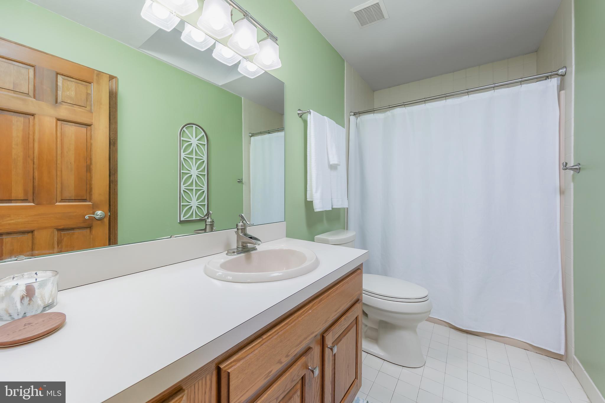 124 Pitman Downer Road Sewell, NJ 08080 - Photo 24 of 71 a bathroom with a sink a toilet and a large mirror