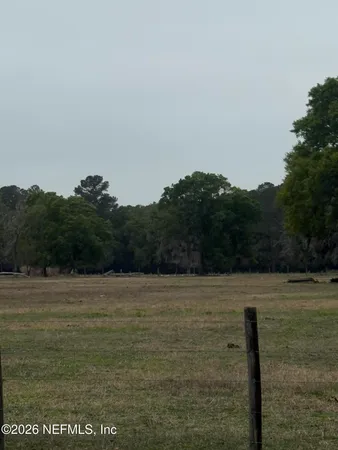 a view of a field with an ocean view