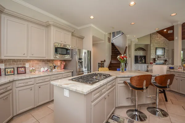 a kitchen with stainless steel appliances granite countertop a sink and cabinets