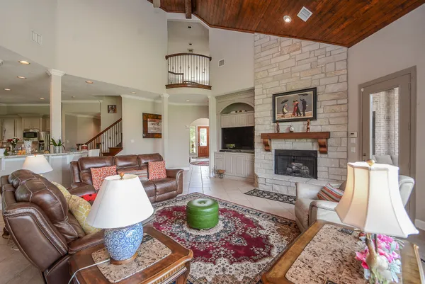 a living room with furniture fireplace and rug