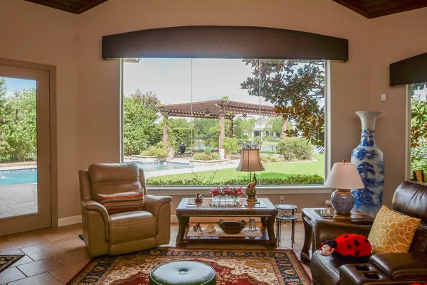 a living room with furniture and a floor to ceiling window