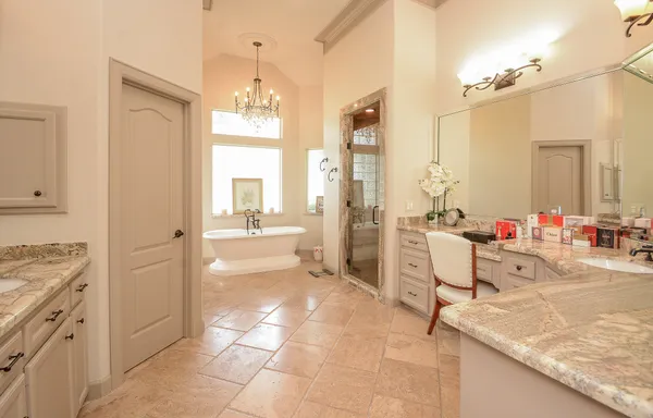 a bathroom with a granite countertop sink a mirror and a bathtub