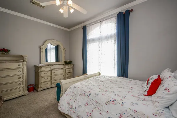 a bedroom with a bed and a dresser