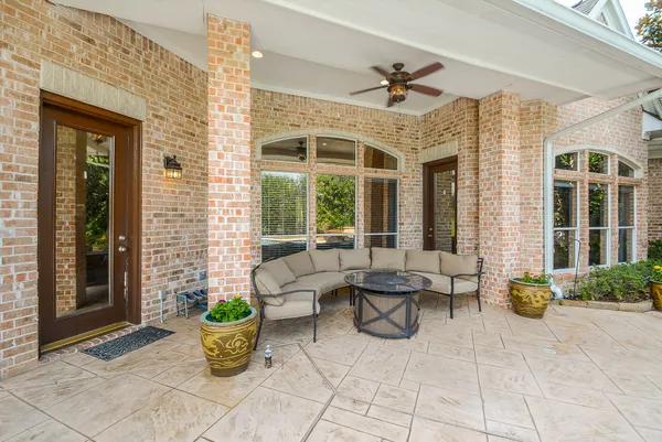 a building outdoor space with patio furniture and potted plants
