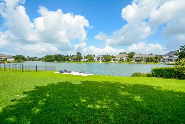 a view of a lake with houses in the back