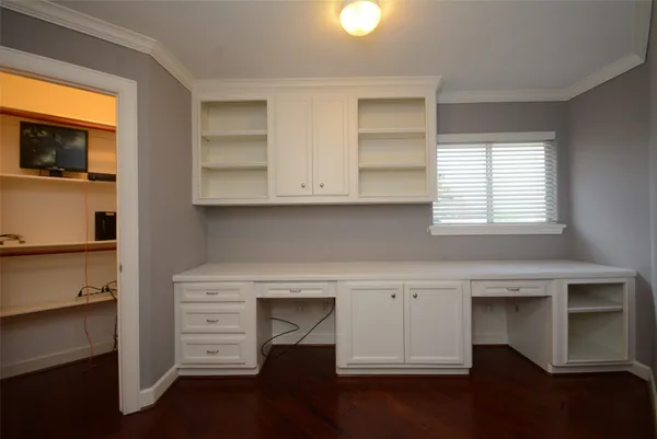 a kitchen with granite countertop a stove a microwave and wooden floor