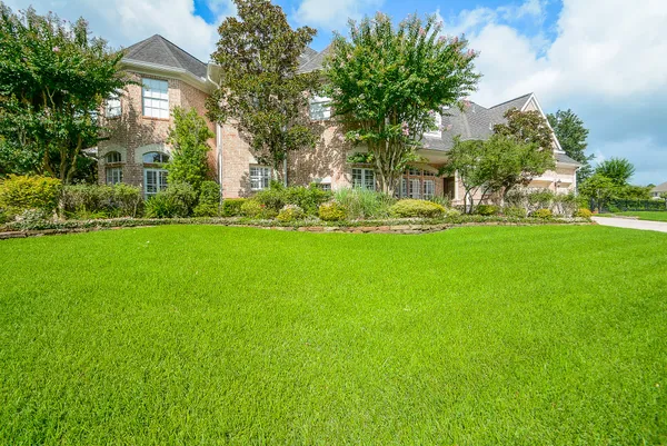 a front view of a house with a garden