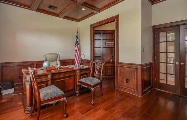 a view of a workspace with furniture and wooden floor