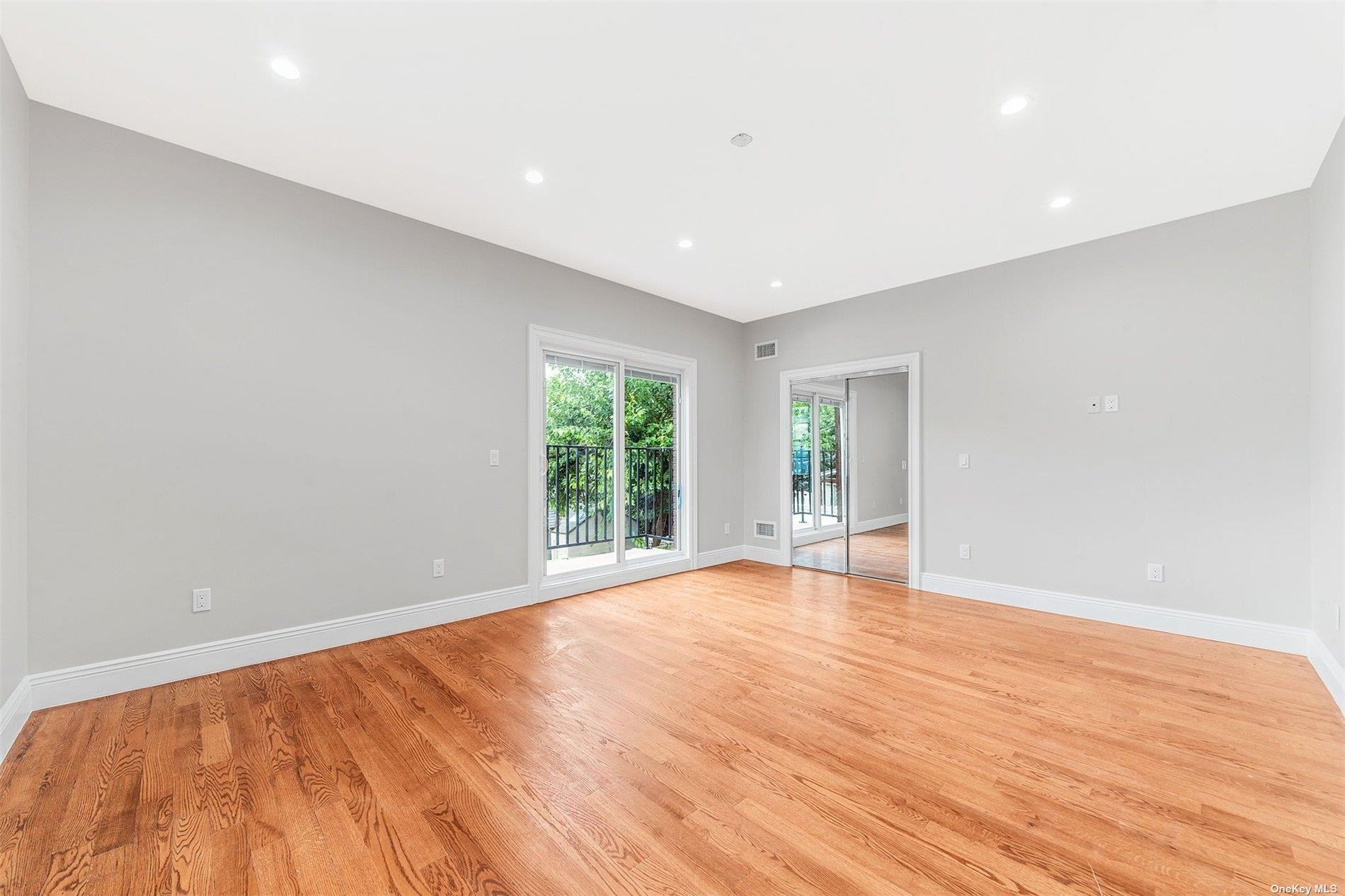22 Solar Lane Albertson, NY 11507 - Photo 12 of 21 a view of an empty room with wooden floor and a window