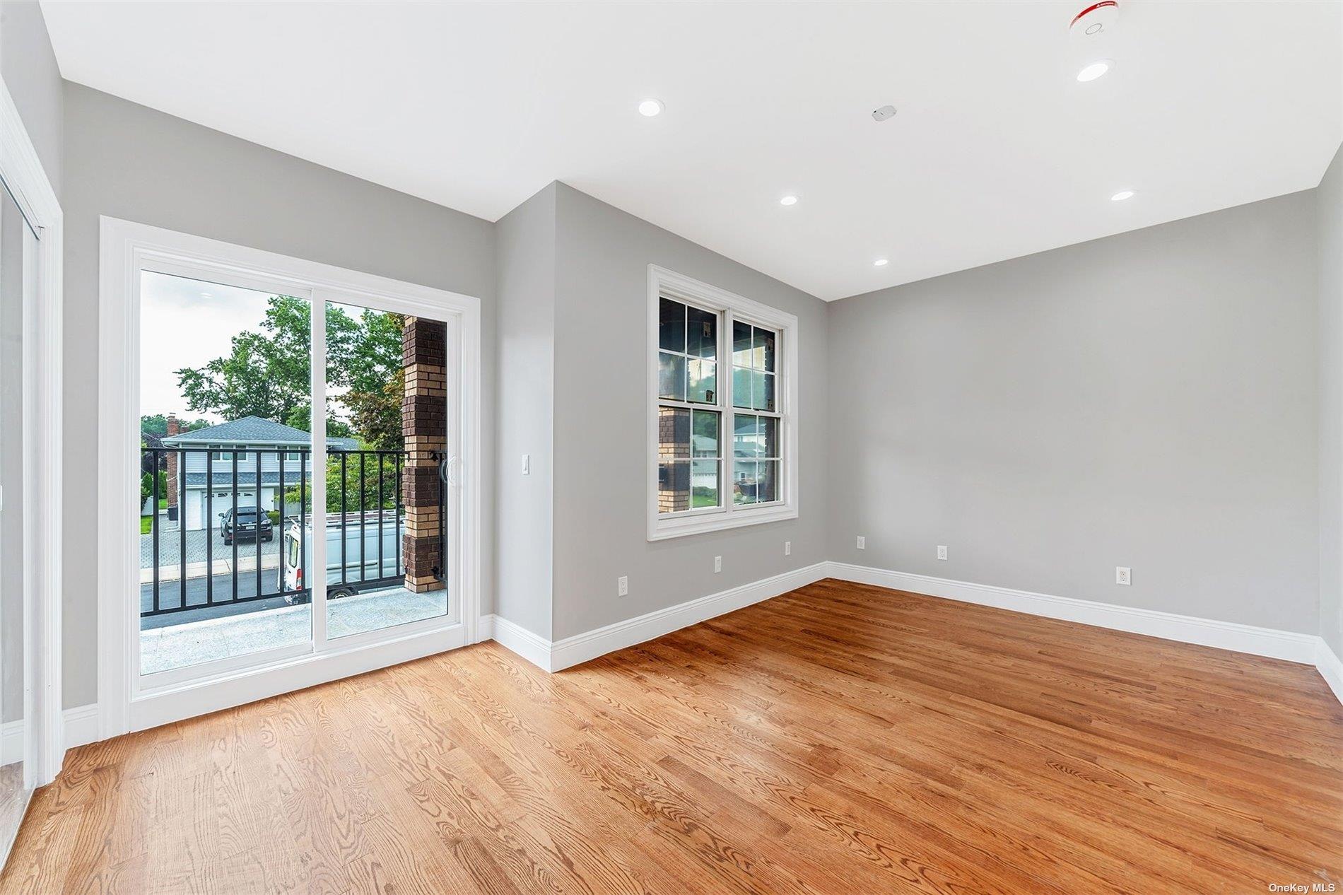 22 Solar Lane Albertson, NY 11507 - Photo 15 of 21 a view of an empty room with wooden floor and a window