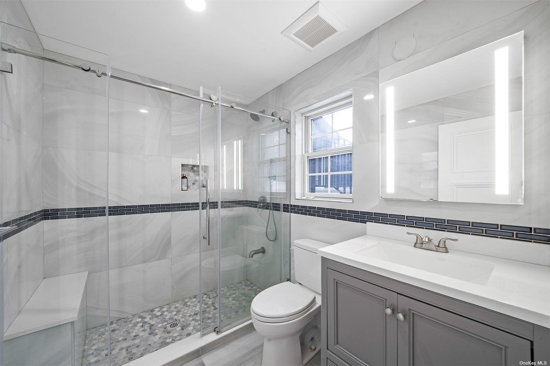 22 Solar Lane Albertson, NY 11507 - Photo 19 of 21 a bathroom with a sink toilet and shower