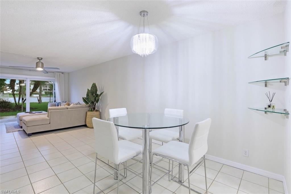 1010 Manatee Road, Unit B101 Naples, FL 34114 - Photo 13 of 26 a living room with furniture and a window