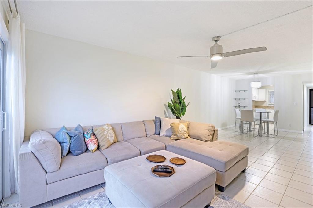 1010 Manatee Road, Unit B101 Naples, FL 34114 - Photo 4 of 26 a living room with furniture and kitchen view