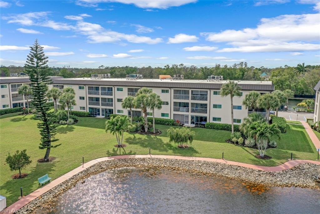 1010 Manatee Road, Unit B101 Naples, FL 34114 - Photo 7 of 26 a view of a garden with a building in the background
