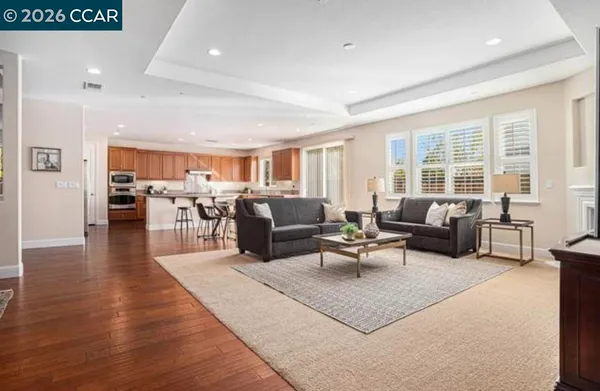 a living room with furniture wooden floor and a large window
