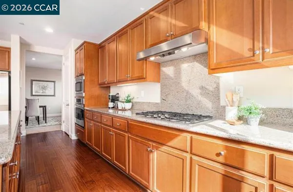 a kitchen with sink cabinets and wooden floor