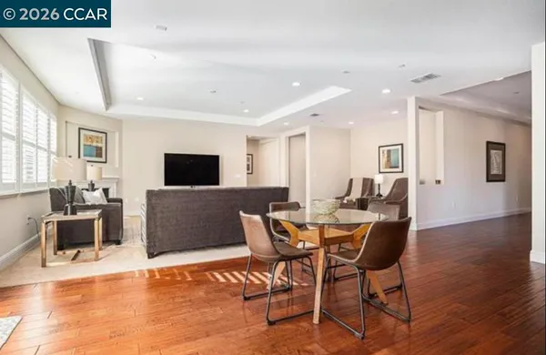 a living room with furniture a flat screen tv and a table