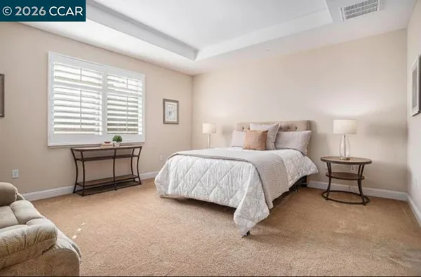 a bedroom with a bed chair and a window