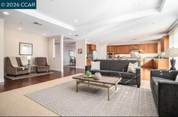a living room with furniture a rug and a table
