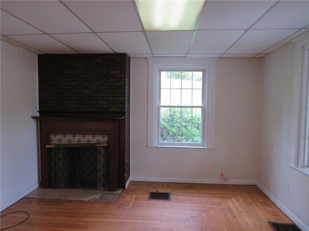 802 Howard Street Monongahela, PA 15063 - Photo 7 of 43 a view of an empty room with wooden floor and a fireplace