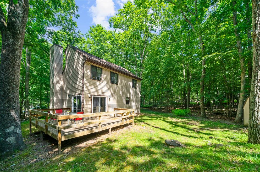 222 Powder Horn Road Henryville, PA 18332 - Photo 19 of 25 A private wooded setting surrounds this charming home with a spacious deck, ideal for outdoor enjoyment.