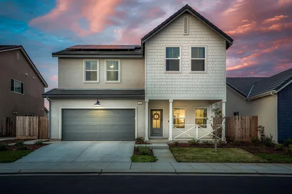 a front view of a house with garage
