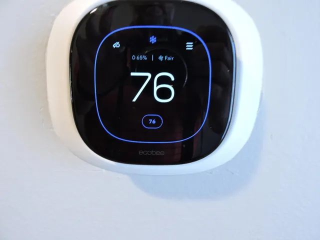 a view of a big room with wooden floor and windows