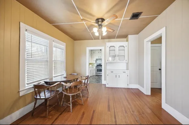 a view of a dining room with furniture and wooden floor