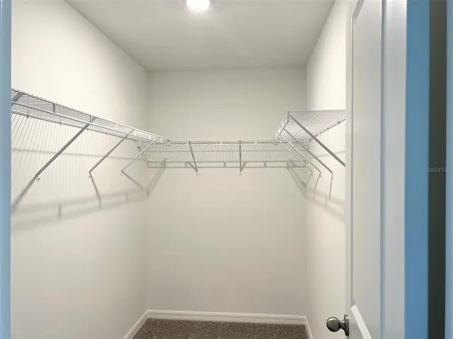 a bathroom with a sink shower and a mirror