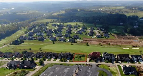 an aerial view of a house with a yard and outdoor seating