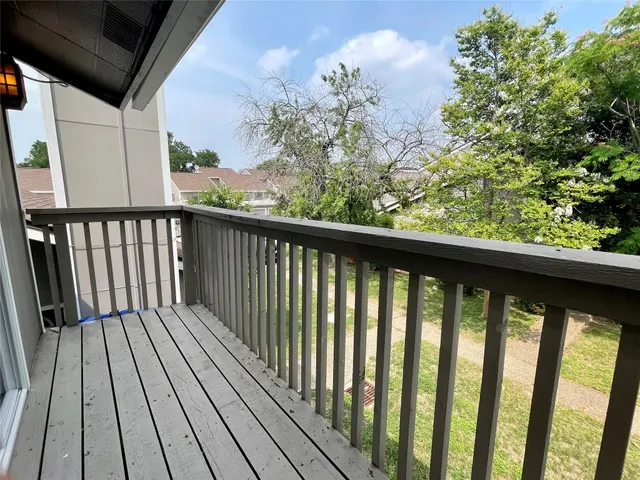 a view of balcony with wooden floor