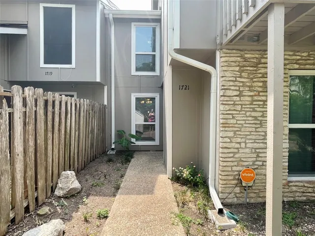 a backyard of a house with potted plants