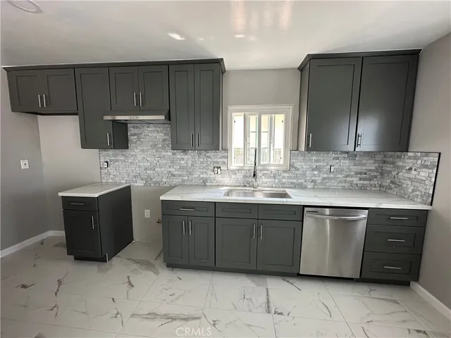a kitchen with stainless steel appliances granite countertop a sink and a stove