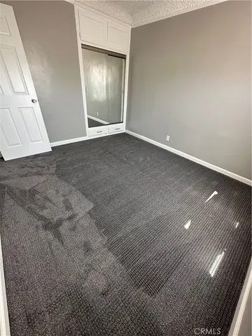 an empty room with wooden floor and entrance